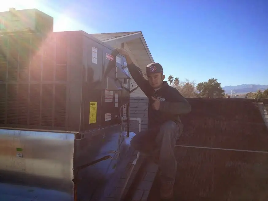 HVAC technician performing HVAC Inspection on a rooftop unit in Fairfax